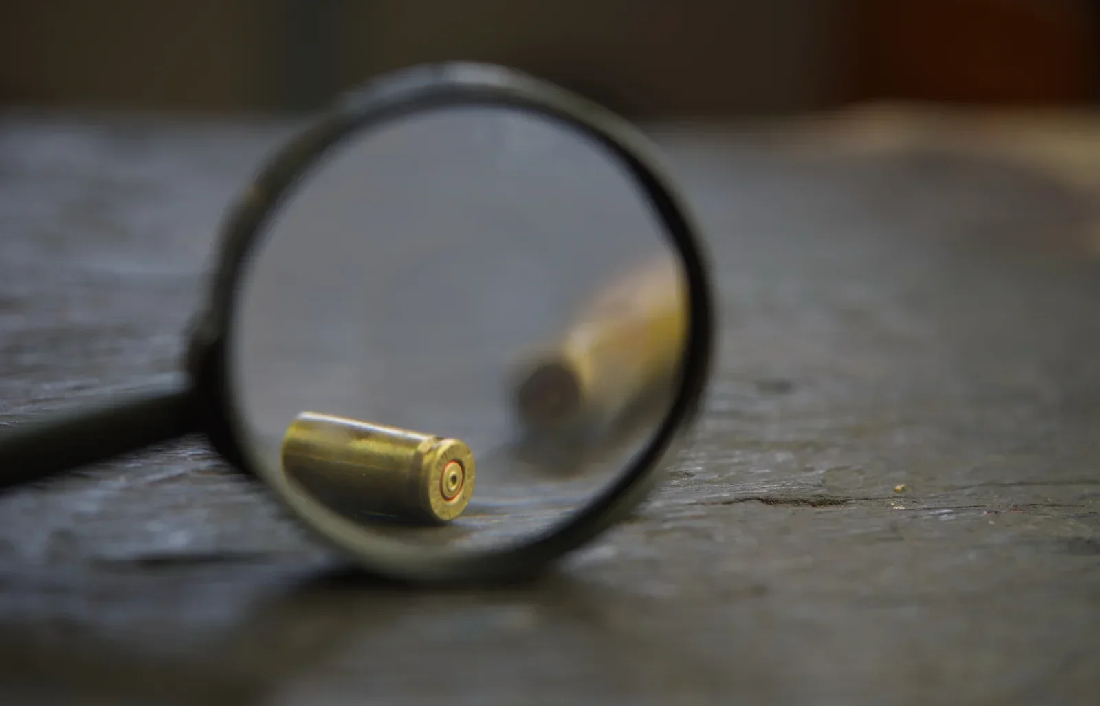Magnifying glass viewing bullet to signify Violent Crimes